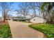 Spacious backyard featuring a large deck, mature trees, detached garage, and a long driveway at 3215 Concord Cir, Smyrna, GA 30080