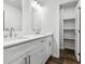 Bathroom showcasing dual vanities, modern finishes, and a linen closet at 3215 Concord Cir, Smyrna, GA 30080