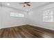 Cozy bedroom showcases vinyl floors, modern ceiling fan, and natural light through the windows at 3215 Concord Cir, Smyrna, GA 30080