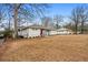 Lovely house with gray brick exterior, showcasing the landscaped front yard and extended driveway at 3215 Concord Cir, Smyrna, GA 30080
