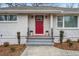Charming home entrance with a red front door, brick steps, and manicured landscaping at 3215 Concord Cir, Smyrna, GA 30080