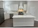 Bright kitchen with an island, stainless steel appliances and white cabinetry and backsplash at 3215 Concord Cir, Smyrna, GA 30080
