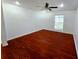 Spacious bedroom featuring gleaming hardwood floors, neutral walls, a ceiling fan, and a bright window, creating a welcoming retreat at 3278 Abbeywood Dr, Decatur, GA 30034