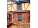 Charming two-story townhouse showcasing brick facade, windows with security bars, and a cozy entrance with an opened security gate at 3278 Abbeywood Dr, Decatur, GA 30034