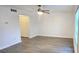 Bright living room featuring wood-look tile flooring, a modern ceiling fan, and neutral-colored walls, creating a welcoming and airy atmosphere at 3278 Abbeywood Dr, Decatur, GA 30034