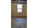 Unfinished basement room with a window and concrete floor at 535 Toonigh Rd, Woodstock, GA 30188