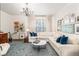 Bright living room featuring a stylish rug, comfortable sofa, and an array of decorative wall art at 100 Brickworks Cir # 102, Atlanta, GA 30307