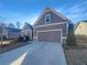 Two-story house with gray siding, two-car garage, and a paved driveway at 3338 Carolina Wren Sw Trl, Marietta, GA 30060