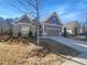 Two-story house with gray siding, brick accents, and a landscaped yard at 3338 Carolina Wren Sw Trl, Marietta, GA 30060