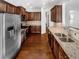 Kitchen with granite countertops, stainless steel appliances, and dark wood cabinets at 3338 Carolina Wren Sw Trl, Marietta, GA 30060