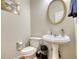 Clean and updated half bathroom with pedestal sink and oval mirror at 1305 Leisure Lake Dr, Lawrenceville, GA 30044
