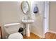 Clean and updated half bathroom with pedestal sink and oval mirror at 1305 Leisure Lake Dr, Lawrenceville, GA 30044