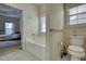 Bathroom with bathtub, toilet, and view of bedroom at 1305 Leisure Lake Dr, Lawrenceville, GA 30044