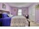 Spacious bedroom with king bed, closet, and purple walls at 1305 Leisure Lake Dr, Lawrenceville, GA 30044