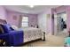 Large bedroom with king bed, closet, and purple walls at 1305 Leisure Lake Dr, Lawrenceville, GA 30044