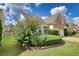 Home exterior showcasing landscaping and two-car garage at 1305 Leisure Lake Dr, Lawrenceville, GA 30044
