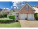 Two-story brick home with a two-car garage and manicured lawn at 1305 Leisure Lake Dr, Lawrenceville, GA 30044