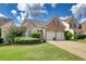 Two-story home with two car garage and manicured lawn at 1305 Leisure Lake Dr, Lawrenceville, GA 30044