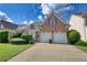 Two-story brick home with a two-car garage at 1305 Leisure Lake Dr, Lawrenceville, GA 30044