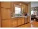 Kitchen with light wood cabinets, stainless steel appliances, and hardwood floors at 1305 Leisure Lake Dr, Lawrenceville, GA 30044