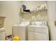 Bright laundry room, featuring washer, dryer, and ample shelving at 1305 Leisure Lake Dr, Lawrenceville, GA 30044