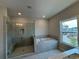 Luxurious bathroom with a walk-in shower and a large soaking tub at 148 Birch Tree Way, Cumming, GA 30040