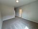 Well-lit bedroom with carpet flooring and access to a bathroom at 148 Birch Tree Way, Cumming, GA 30040