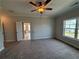 Bright bedroom featuring a large window and en-suite bathroom access at 148 Birch Tree Way, Cumming, GA 30040