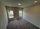 Spacious bedroom with two windows and carpeted floors at 148 Birch Tree Way, Cumming, GA 30040
