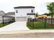 Attached garage with a spacious driveway and fenced yard at 148 Birch Tree Way, Cumming, GA 30040