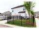 White house with black fence, green lawn, and attached garage at 148 Birch Tree Way, Cumming, GA 30040