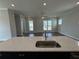 Modern kitchen island with quartz countertops and stainless steel sink at 148 Birch Tree Way, Cumming, GA 30040