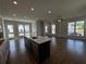 Open concept kitchen with island and hardwood floors at 148 Birch Tree Way, Cumming, GA 30040