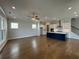 Spacious living room with hardwood floors and a view of the kitchen and staircase at 148 Birch Tree Way, Cumming, GA 30040
