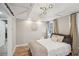 Comfortable bedroom featuring white trim, a stylish light fixture, and hardwood floors at 4731 Unicoi Pl, Douglasville, GA 30135