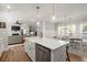 Modern kitchen with white cabinetry, stainless steel appliances, and an island with bar seating at 981 Rittenhouse Way, Atlanta, GA 30316