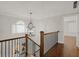 Upstairs hall with hardwood floors, chandelier, and views to the entry at 3509 Billingsley Dr, Marietta, GA 30062