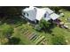 Aerial view of a charming farmhouse with expansive gardens at 10975 Hutcheson Ferry Rd, Chattahoochee Hills, GA 30268