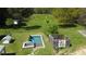 Aerial view of a fenced-in pool with a hot tub next to it, plus a colorful quilt-themed structure and treehouse at 10975 Hutcheson Ferry Rd, Chattahoochee Hills, GA 30268