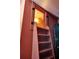 Attic ladder featuring heart shaped railing and a view to the light fixture above at 10975 Hutcheson Ferry Rd, Chattahoochee Hills, GA 30268