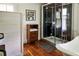 Bathroom featuring hardwood floors, a glass shower, and a modern freestanding tub at 10975 Hutcheson Ferry Rd, Chattahoochee Hills, GA 30268