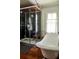 Bathroom featuring hardwood floors, a glass shower, and a modern freestanding tub at 10975 Hutcheson Ferry Rd, Chattahoochee Hills, GA 30268