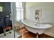 Bathroom featuring hardwood floors, a glass shower, and a vintage clawfoot tub at 10975 Hutcheson Ferry Rd, Chattahoochee Hills, GA 30268