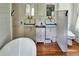 Bright bathroom featuring vintage sinks, hardwood floors, and modern fixtures at 10975 Hutcheson Ferry Rd, Chattahoochee Hills, GA 30268