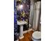Bathroom featuring floral wallpaper, pedestal sink with gold fixtures and a toilet with a patterned shower curtain at 10975 Hutcheson Ferry Rd, Chattahoochee Hills, GA 30268