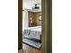 Bedroom with hardwood floors, modern ceiling fan, and a large bed with white linens at 10975 Hutcheson Ferry Rd, Chattahoochee Hills, GA 30268