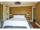 Bedroom with hardwood floors, large bed with white linens, with mid-century modern end tables at 10975 Hutcheson Ferry Rd, Chattahoochee Hills, GA 30268