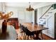 Dining room featuring a wooden table, vintage chandelier, and a classic writing desk at 10975 Hutcheson Ferry Rd, Chattahoochee Hills, GA 30268