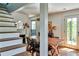 Dining room with hardwood floors, fireplace, dining tables and chairs and doors leading to the garden at 10975 Hutcheson Ferry Rd, Chattahoochee Hills, GA 30268
