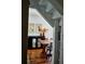 Dining room with hardwood floors features wooden table with chairs and a dark wood buffet with mirrored doors at 10975 Hutcheson Ferry Rd, Chattahoochee Hills, GA 30268